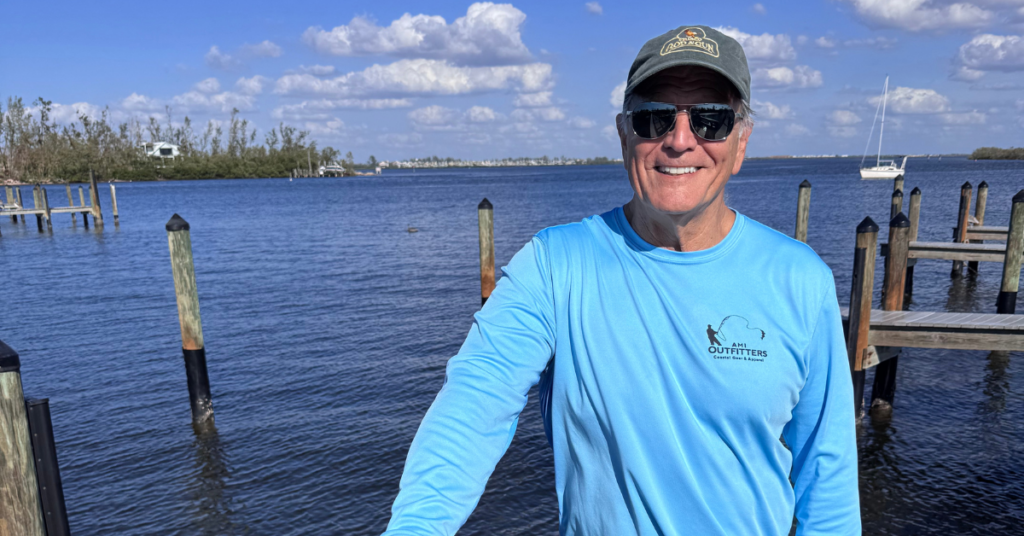 Don Hempel wearing blue shirt with water behind